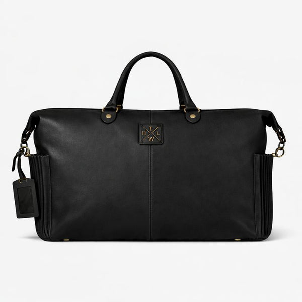 Black leather duffel bag with gold accents on a white background