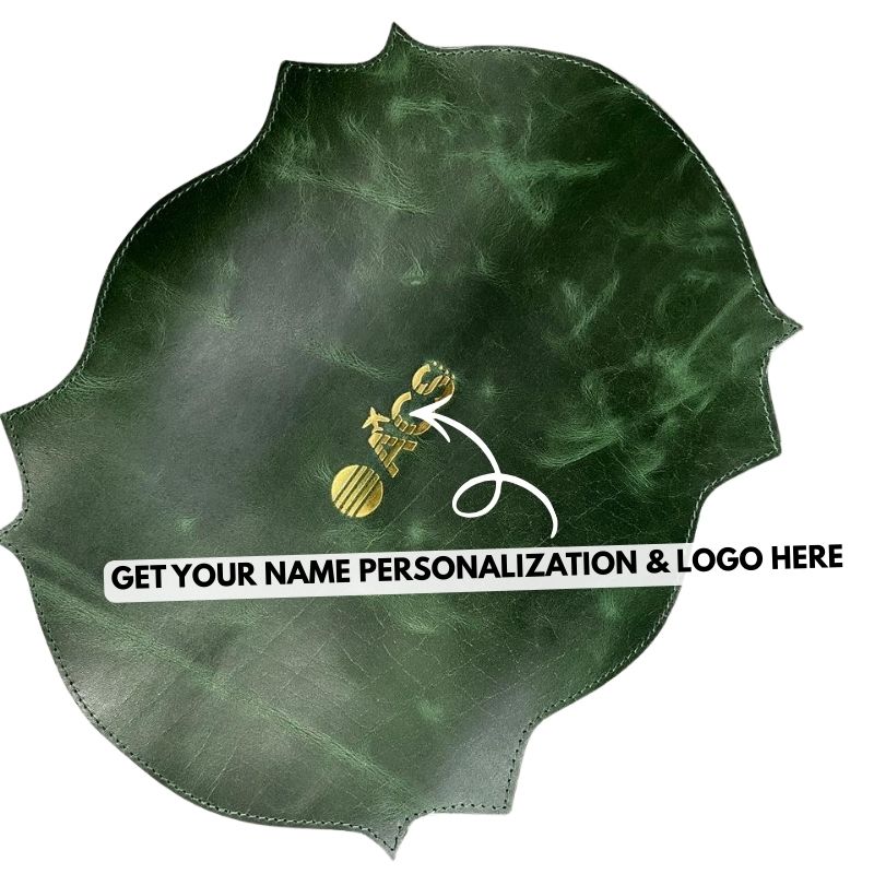 Green leather place mat with gold logo and text space for personalization on a white background