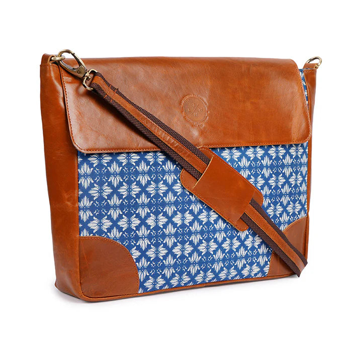 Brown leather and blue patterned fabric bag on a white background