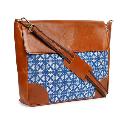 Brown leather and blue patterned fabric bag on a white background