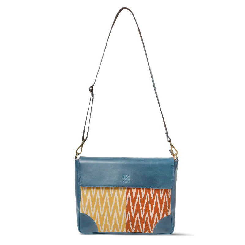 Blue crossbody bag with a colorful geometric pattern on a white background