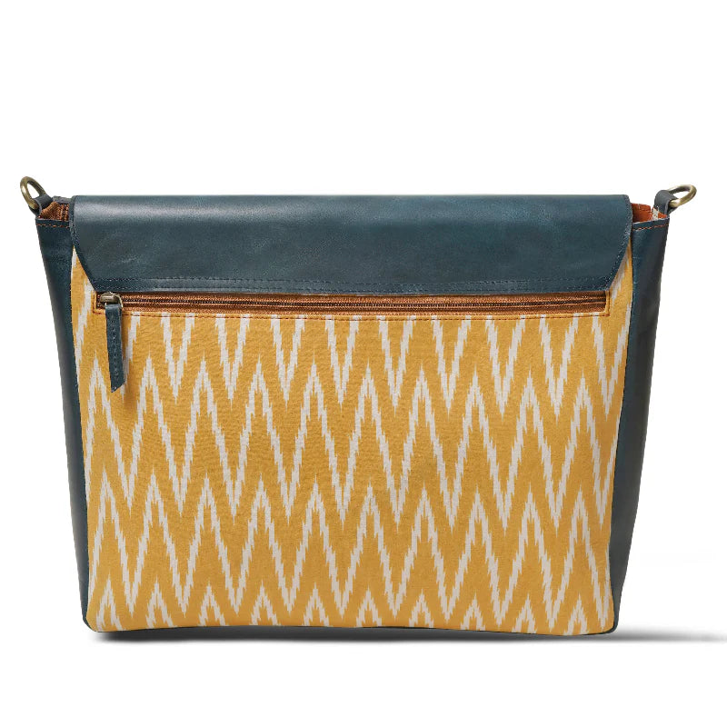 Handbag with blue top section and yellow patterned bottom on a white background