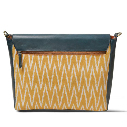 Handbag with blue top section and yellow patterned bottom on a white background