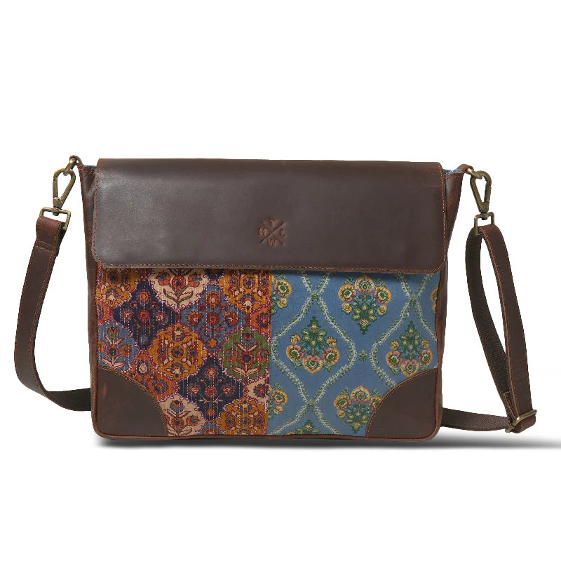 Brown leather crossbody bag with patterned flap on a white background