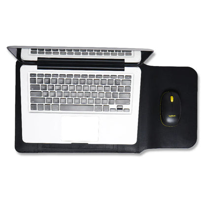 Laptop on a black desk pad / sleeve with a mouse to the right