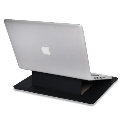 Silver laptop with Apple logo on a black stand on sleeve against a white background