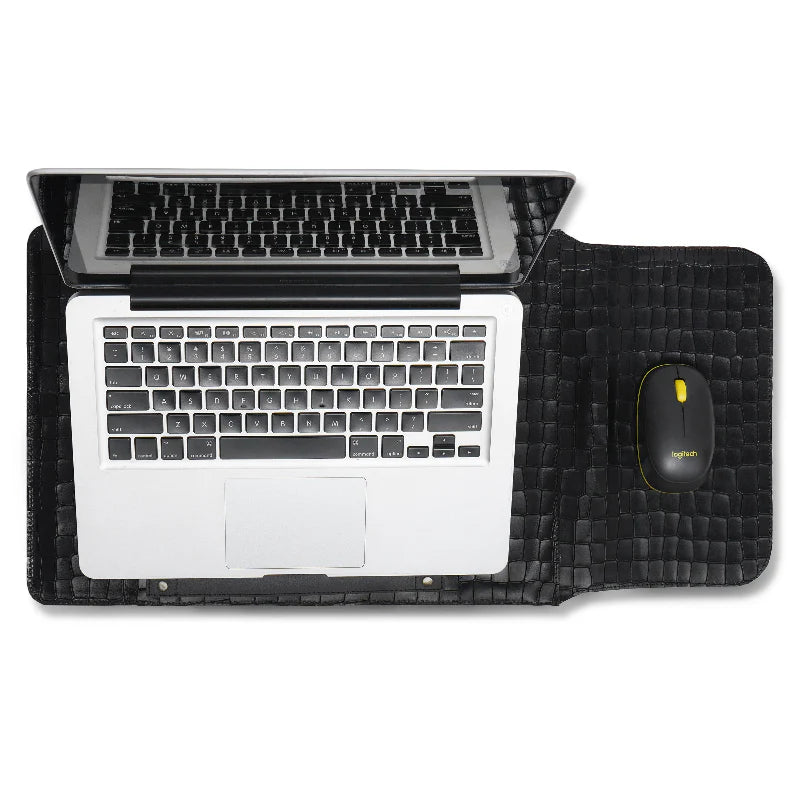 Laptop on a black desk mat/sleeve with a mouse, on a white background