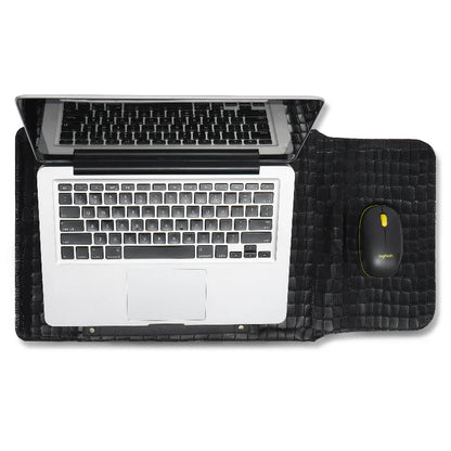 Laptop on a black desk mat/sleeve with a mouse, on a white background