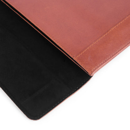 Close-up of a brown leather sleeve with a black interior