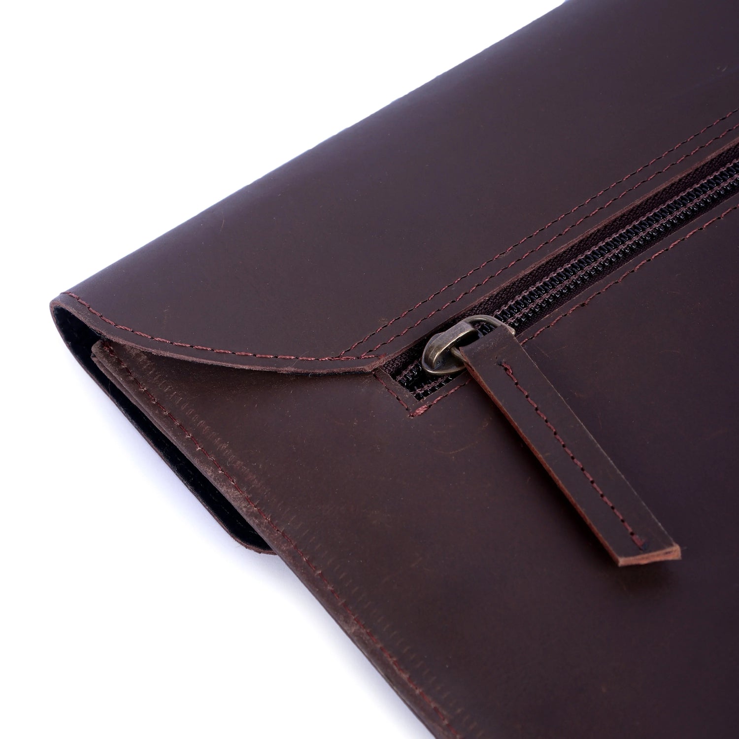 Brown leather clutch bag with zipper on a white background