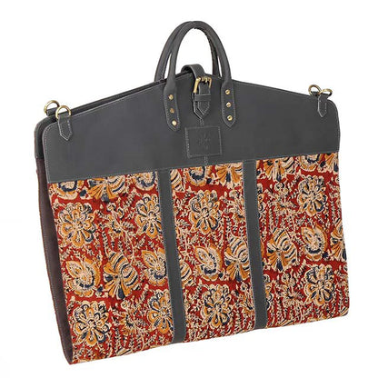 garment bag with floral pattern and dark leather accents on a white background