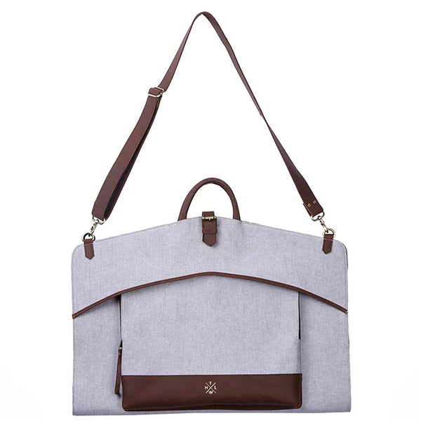 Gray bag with brown accents and a strap on a white background