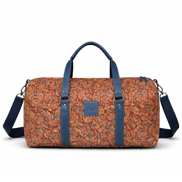 Patterned duffel bag with blue straps on a white background