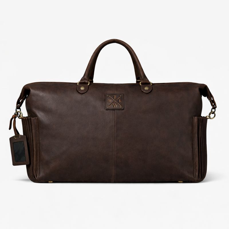 Brown leather duffel bag with multiple pockets on a white background