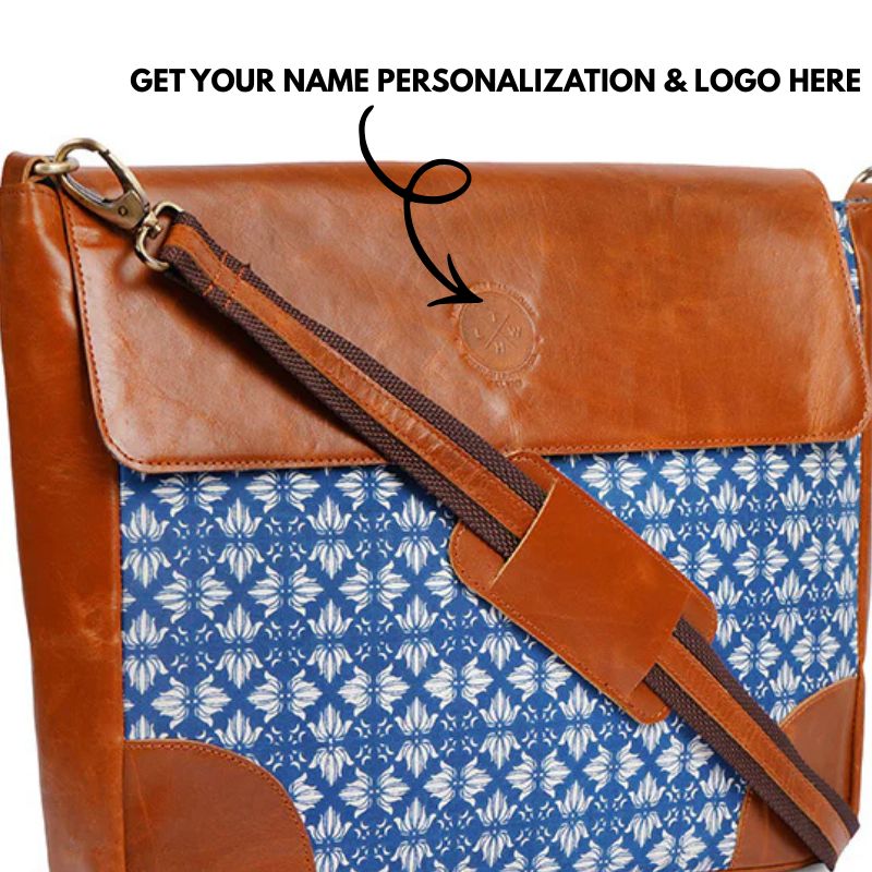 Brown leather bag with blue patterned interior and customizable name and logo text.
