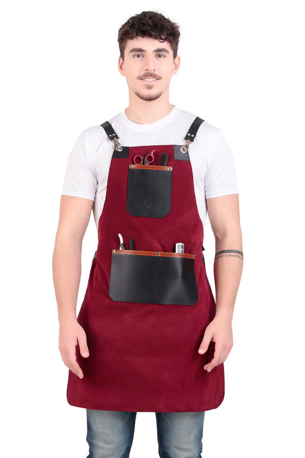 Man wearing a red apron with black leather pockets on a white background