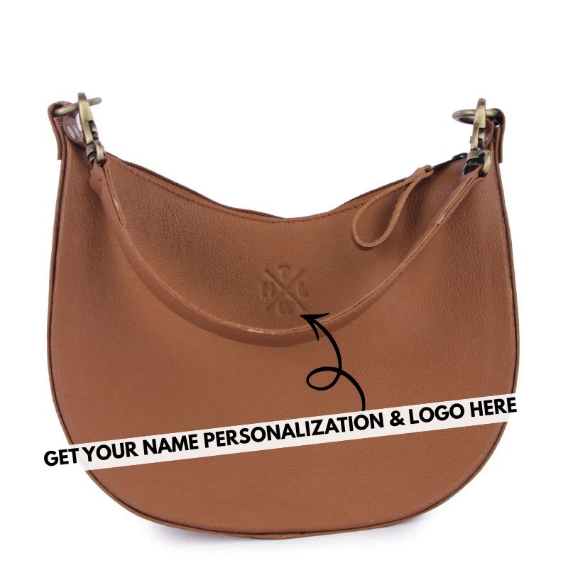 Brown leather sling  handbag with a visible brand logo on a white background