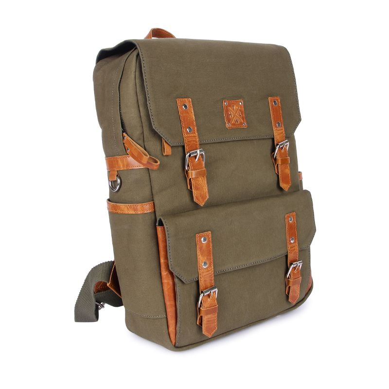 Green backpack with brown leather straps on a white background