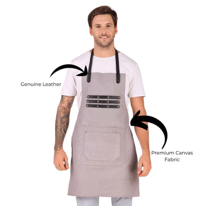 Man wearing a gray apron with leather accents on a white background