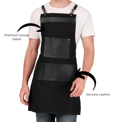 Person wearing a black apron with premium canvas fabric and genuine leather details on a white background.