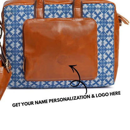 Blue floral-patterned bag with brown leather patch on a white background