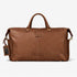 Brown leather duffel bag with a visible brand tag on a white background