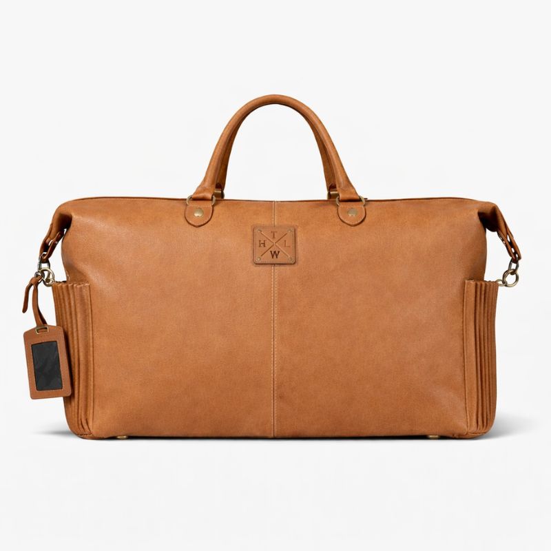 Brown leather duffel bag with a visible brand tag on a white background