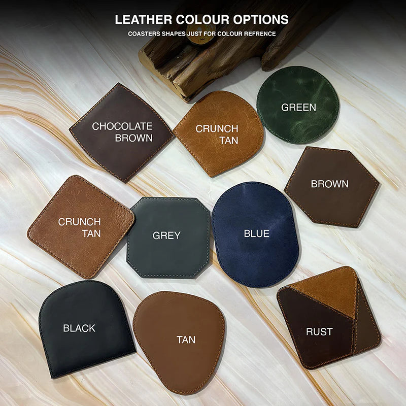 Collection of leather coasters in various colors on a marble surface.