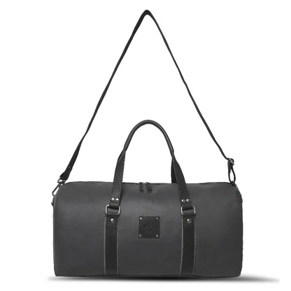 Black duffel bag with a strap on a white background