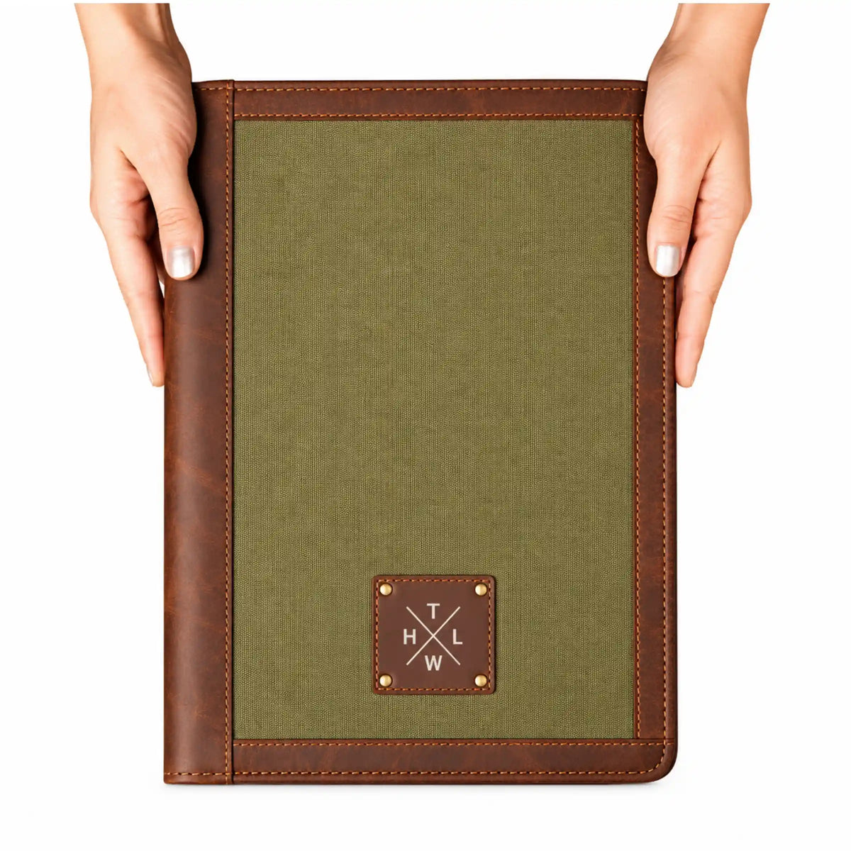 Olive green canvas folder with brown leather borders and a branded leather patch