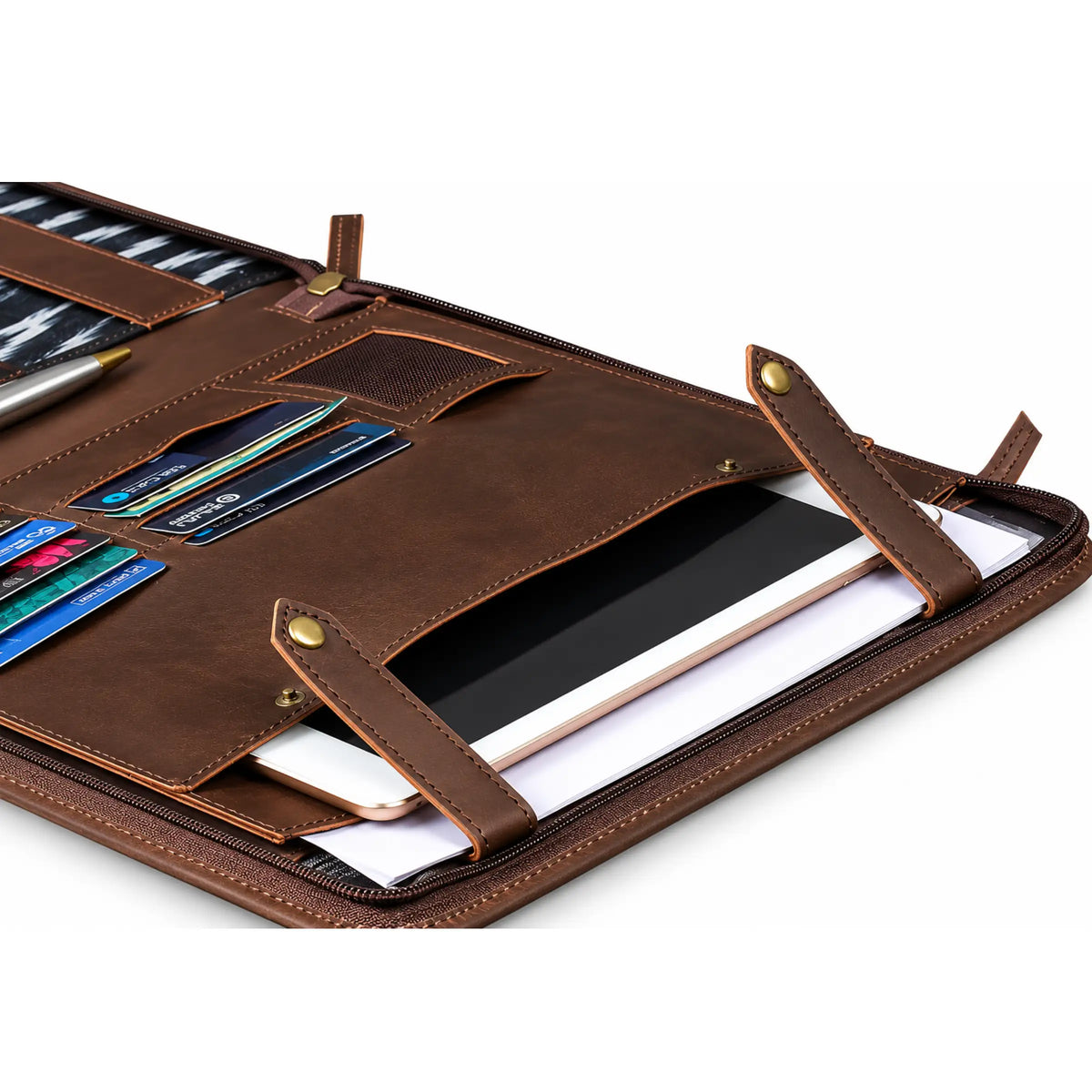 A brown leather organizer sleeve shown open, containing card slots, a pen, a tablet, and papers, photographed on a clean white background.