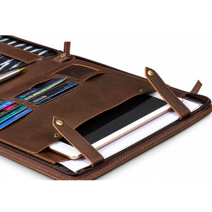 A brown leather organizer sleeve shown open, containing card slots, a pen, a tablet, and papers, photographed on a clean white background.