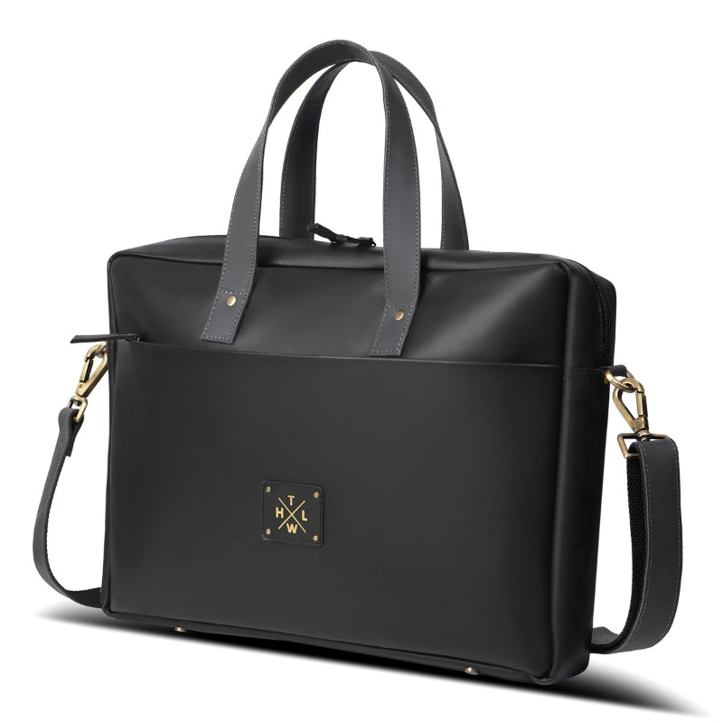 Black handbag with gold accents on a white background