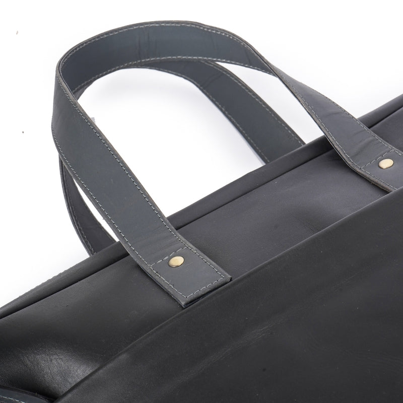 Black leather bag with a strap on a white background