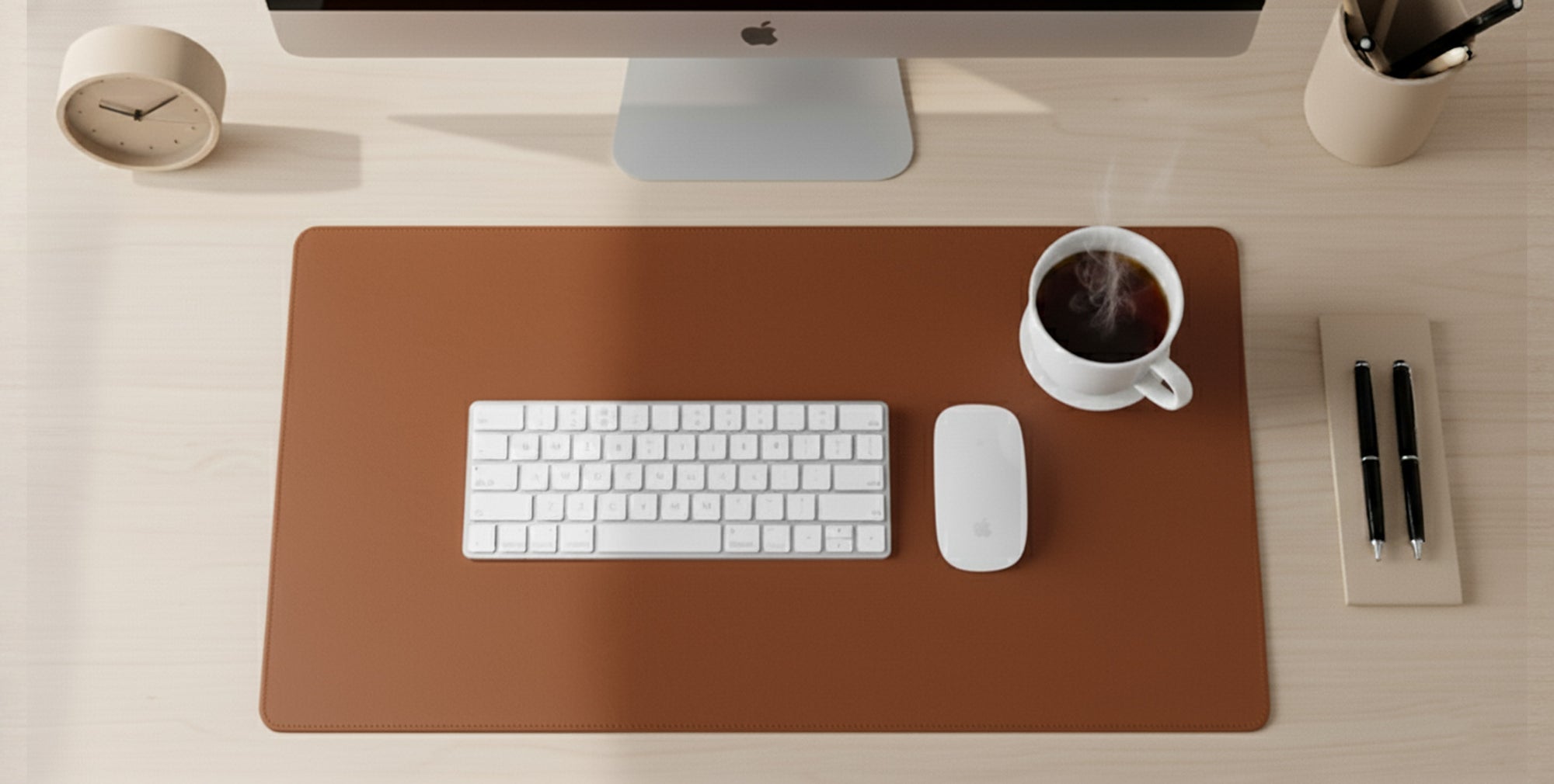 Desk setup with a keyboard, mouse, and coffee cup on a brown mat.