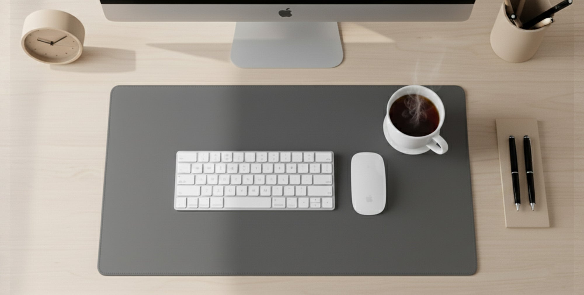 Desk setup with keyboard, mouse, and coffee cup on a large mouse pad.