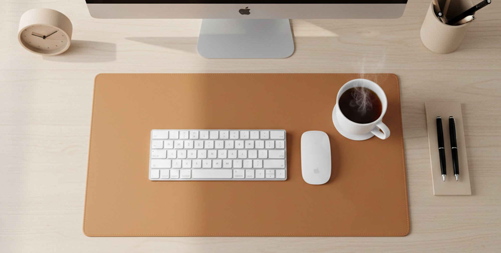 Minimalist desk setup with keyboard, mouse, and coffee cup on a large mouse pad.