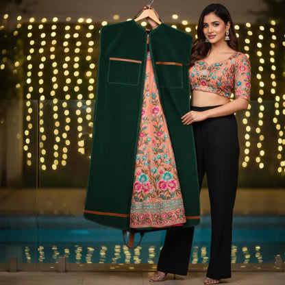 Woman holding a green jacket over a floral outfit with a blurred lights background