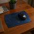 Black gaming mouse on a blue mouse pad with a visible &