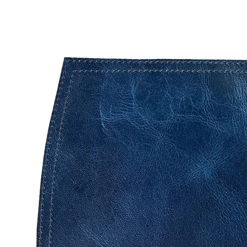 Close-up of a blue leather surface with visible stitching