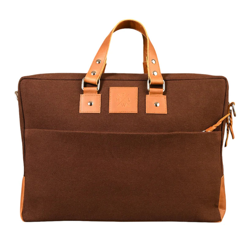 Brown bag with leather straps on a white background