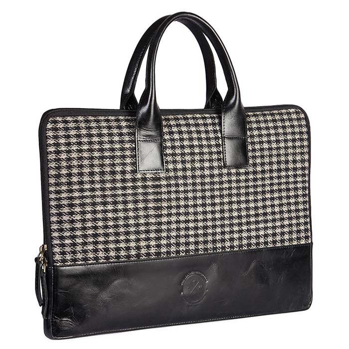 Black and white houndstooth patterned briefcase with black leather accents on a white background