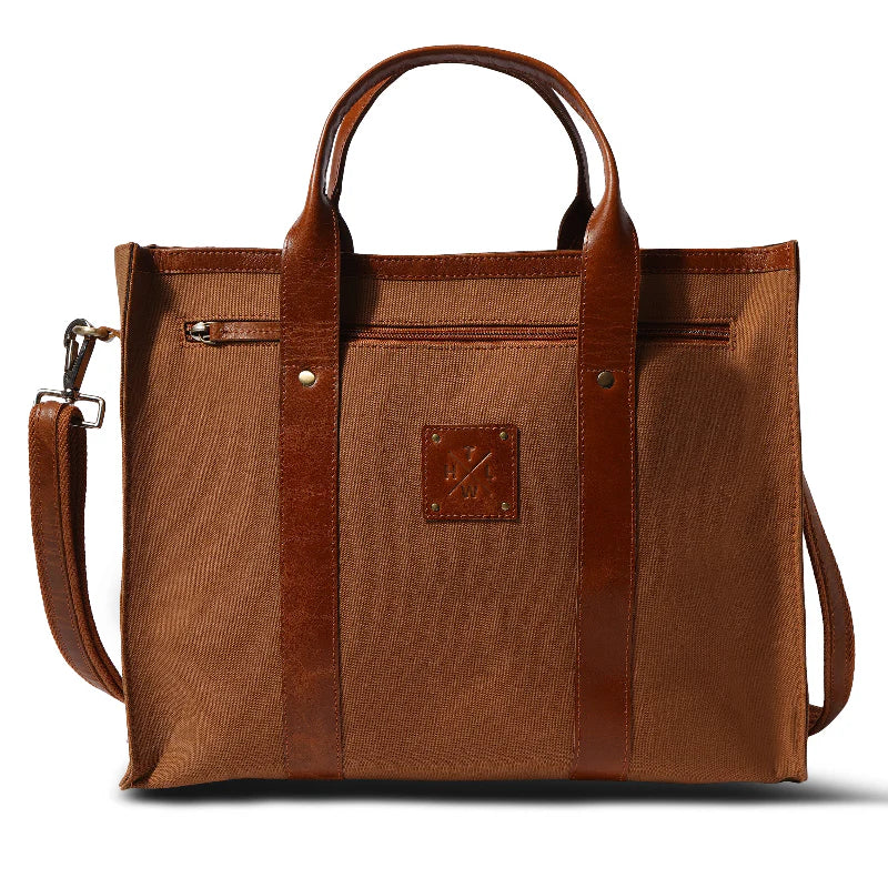 Brown tote bag with leather accents on a white background