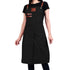 Black apron with brown leather straps worn by a person on a white background