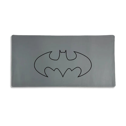 Gray mouse pad with a black Batman logo on a white background