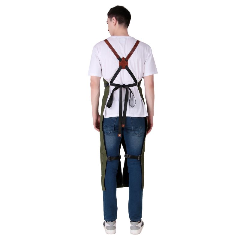 Person wearing a green apron with strap on a white background
