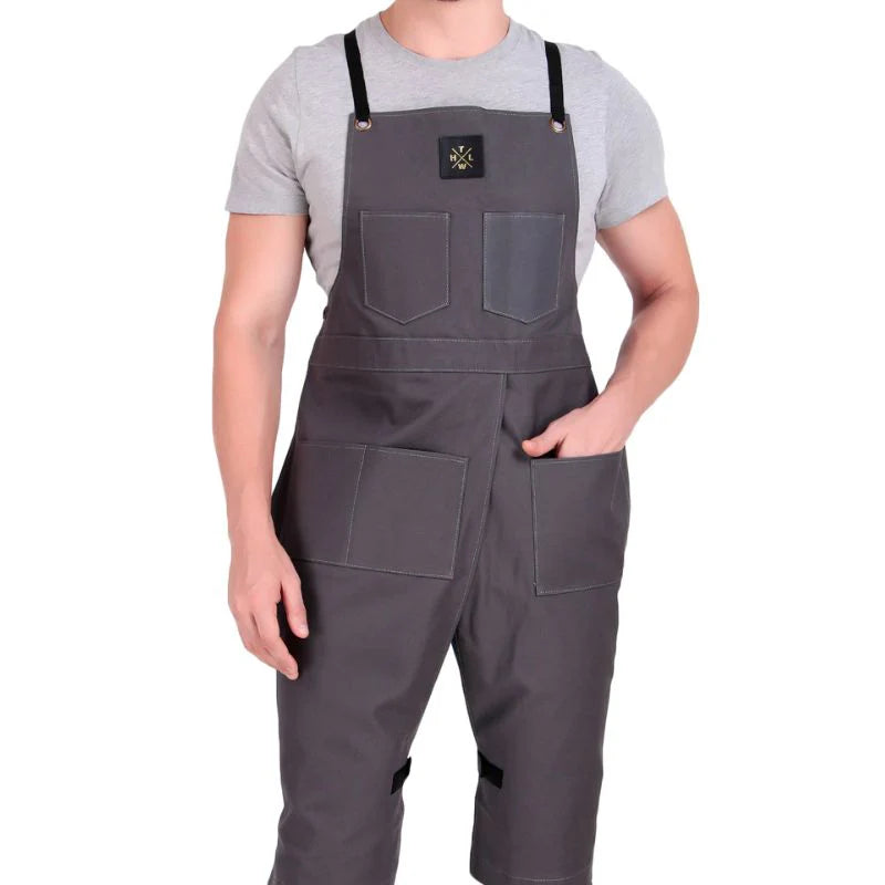 Person wearing a gray bib overalls on a white background