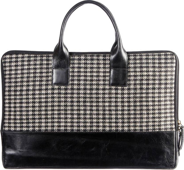 Handbag with houndstooth pattern and black leather accents on a white background