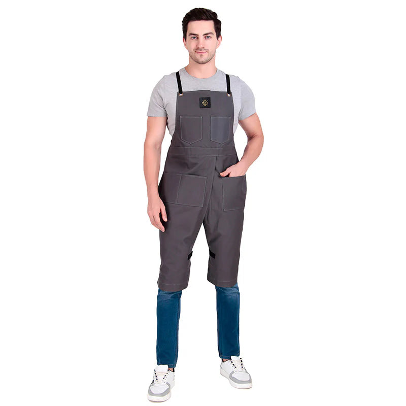 Man wearing gray bib overalls on a white background