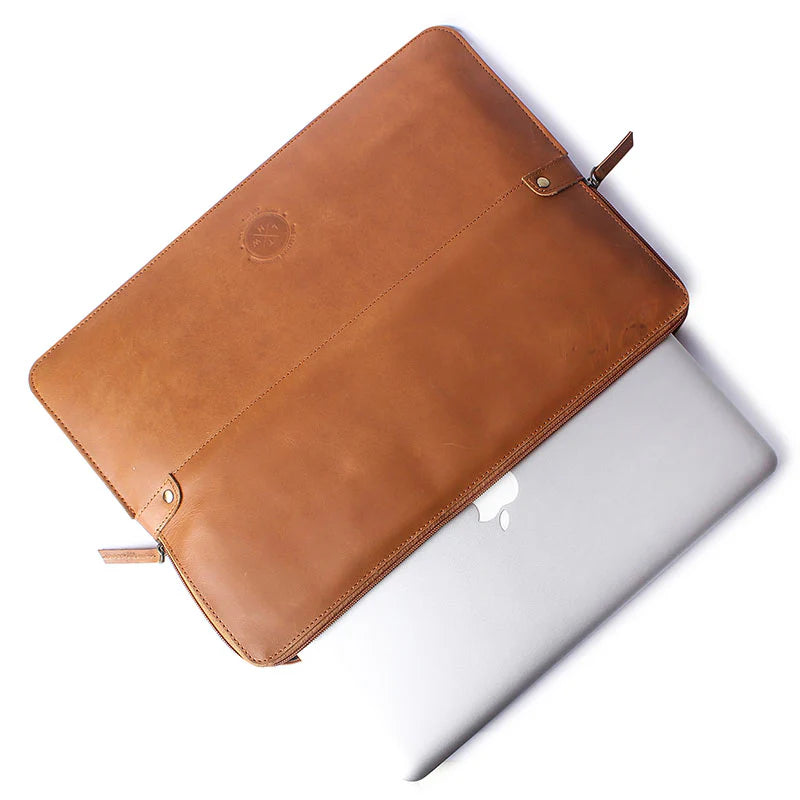 Brown leather laptop sleeve on a white surface